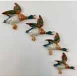 A graduated set of four Beswick wall mounted flyin