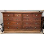 A 20th century pine bank of drawers, set with eigh