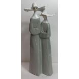 A Lladro group figure of nuns, 33cm high