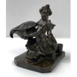 An inkstand in the form of Triton riding a dolphin,