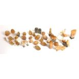 A large collection of orange aventurine quartz and alabaster models of animals