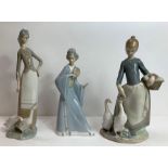 Two Lladro figures, each feeding geese, along with