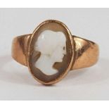 An oval brown shell cameo ring, with tapering shou