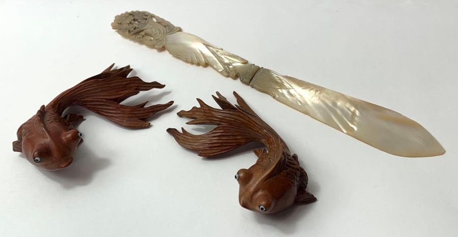 Two wooden Chinese models of fish, along with a mo