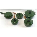 A five piece unused green Le Creuset cooking set