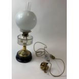 A Victorian table lamp, with a glass reservoir, en