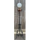 A Victorian oil lamp, standing on a tripod metal b