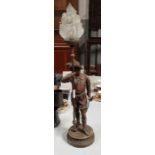 A spelter figure of a standing male in the