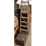 Wooden step ladder along with a tin trunk