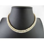 A two row pearl necklace, the 82/76 slightly gradu