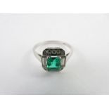 A diamond and emerald ring, the white mount stampe