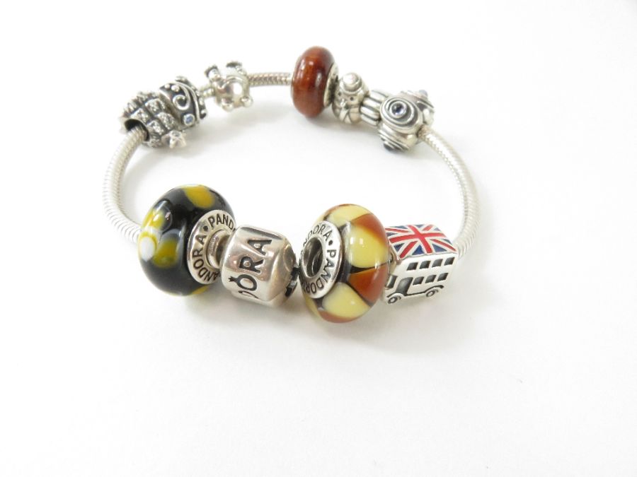 Pandora; a silver bracelet with three glass beads,