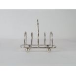 A late Victorian silver four division toast rack,