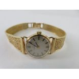 A 9ct gold ladies Omega wrist watch, the round champagne di