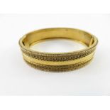 A Victorian hinged gold bangle, unmarked, circa 18