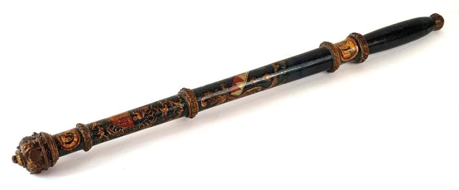A painted and carved wooden baton bearing the mott