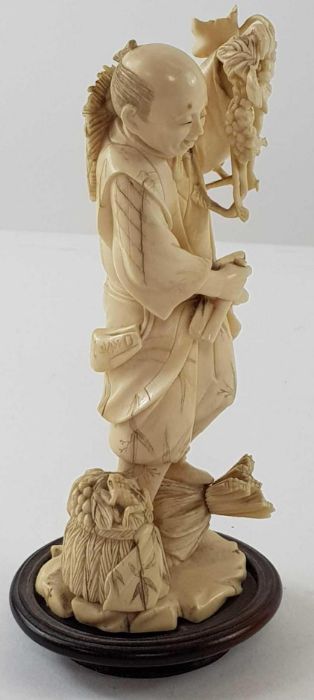 A Japanese ivory carved figure of a lady holding f - Image 20 of 20