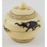 An ivory two handled pot and cover, decorated with