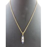 A 9ct gold tanzanite and diamond pendant, on a 9ct