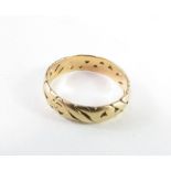 A band ring with cut out decoration, marked '14k',