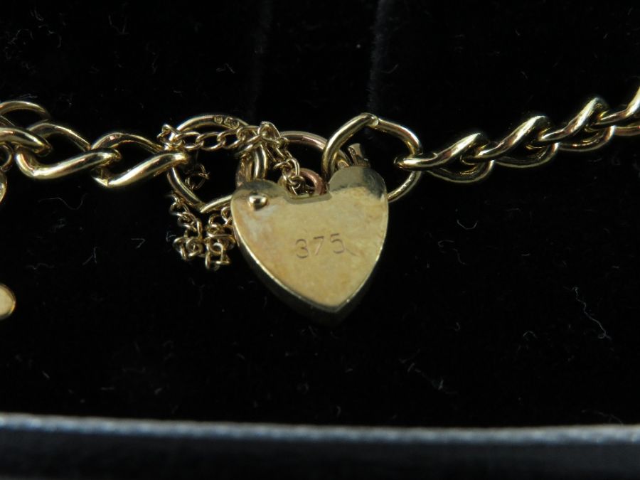 A curb link charm bracelet stamped '375', with hea - Image 3 of 5