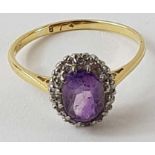 An amethyst and diamond cluster ring, the oval ame