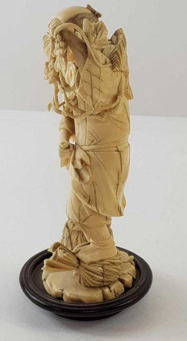 A Japanese ivory carved figure of a lady holding f - Image 19 of 20