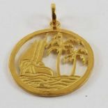 A round pendant with cut out decoration of a boat