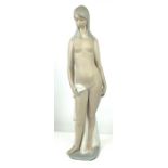 A Lladro figure of a standing nude, in a matt glaz