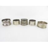 A pair of silver napkin rings, another silver napk