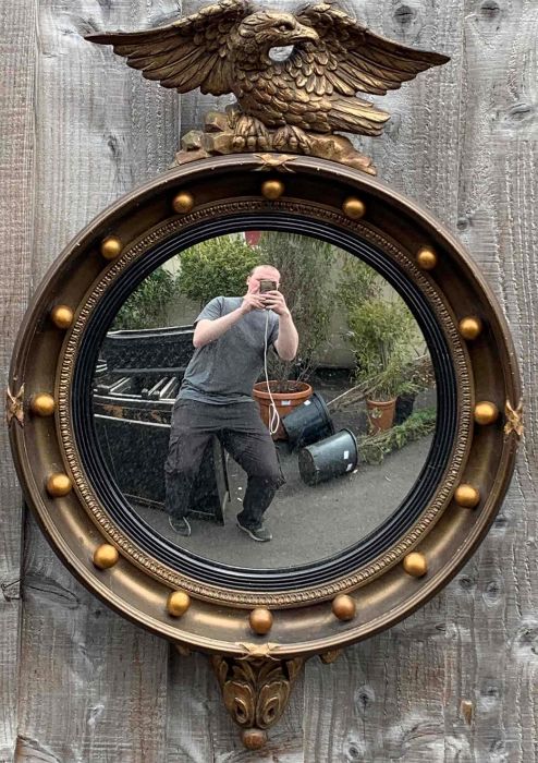A Regency style gilt and gesso convex wall mirror