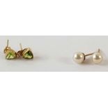 A pair of 9ct gold stud earrings set with a single