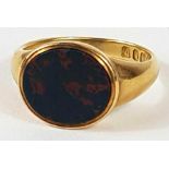 An 18ct gold signet ring, the oval bloodstone set