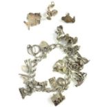 A silver charm bracelet with various charms attach