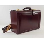 An unused brown leather doctors briefcase