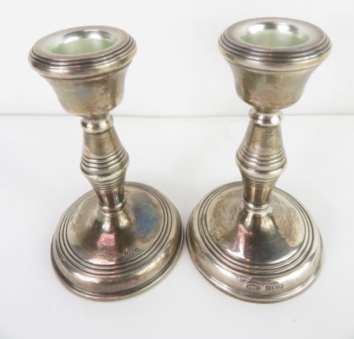 A pair of silver loaded candle sticks, Birmingham
