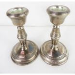 A pair of silver loaded candle sticks, Birmingham