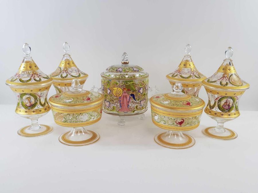 Four footed glass jars with covers, decorated thro