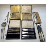 Three cased sets of butter knives with silver hand