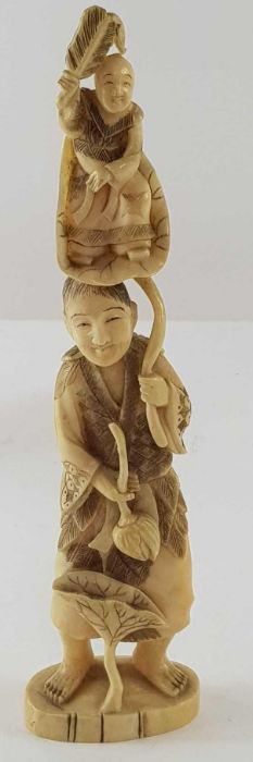 A Japanese ivory carved figure of a lady holding f - Image 14 of 20