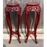 A pair of Chinese mahogany torchere stands, 91cm h
