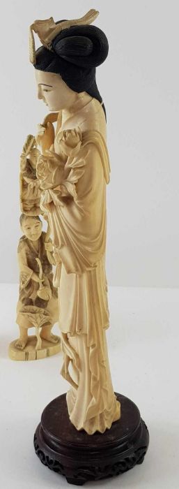 A Japanese ivory carved figure of a lady holding f - Image 12 of 20