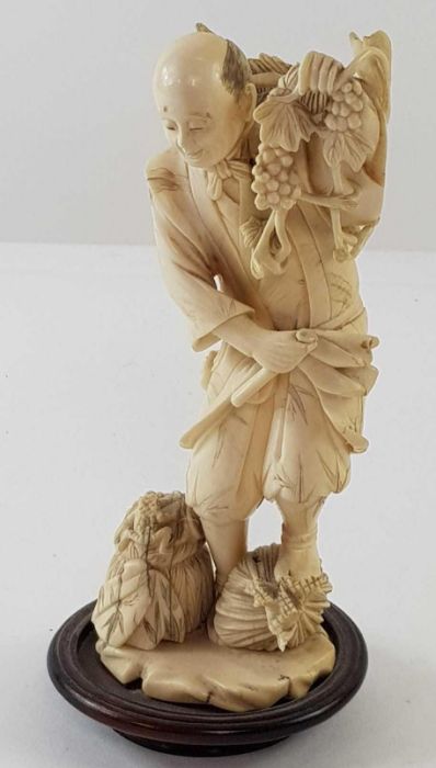 A Japanese ivory carved figure of a lady holding f - Image 18 of 20