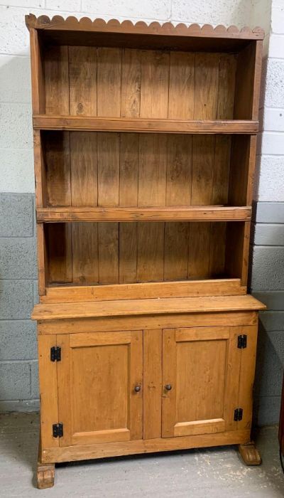 A pine two section dresser, with two fitted shelve