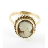 A brown shell cameo ring, marked '9ct', finger siz