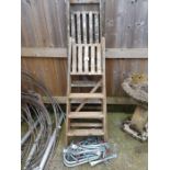 2 wooden step ladders along with a metal chain lad