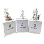 Three Lladro figures, including snowman, girl hold