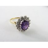 An 18ct gold amethyst and diamond cluster ring, th