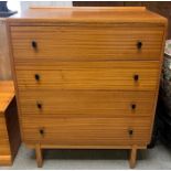 A mid century teak chest of drawers, with four lon