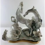 A large Lladro porcelain sculpture of three horses